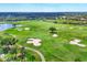 Aerial view featuring manicured golf course with sand traps, lush greenery, and beautiful landscaping at 3519 Founders Club Dr, Sarasota, FL 34240