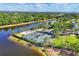 Beautiful aerial shot of the community's tennis courts, waterfront views, and lush landscaping at 3519 Founders Club Dr, Sarasota, FL 34240