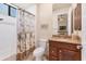 Bathroom with tiled shower/bath combination with a shower curtain and granite vanity at 3519 Founders Club Dr, Sarasota, FL 34240