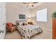 Comfortable bedroom with a ceiling fan, woven chair and tropical-themed bedding at 3519 Founders Club Dr, Sarasota, FL 34240