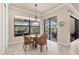Bright breakfast nook features a glass table, seating for four, and a large window view to the outdoor living area at 3519 Founders Club Dr, Sarasota, FL 34240