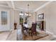 Elegant dining room featuring decorative windows, a stylish light fixture, and a complementary rug at 3519 Founders Club Dr, Sarasota, FL 34240