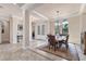 Dining area featuring stylish lighting and furniture, with seamless access to the foyer at 3519 Founders Club Dr, Sarasota, FL 34240