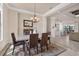 Bright dining room with an elegant chandelier, view to kitchen, and neutral tones creating a welcoming atmosphere at 3519 Founders Club Dr, Sarasota, FL 34240