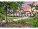Gorgeous home with lush landscaping, healthy trees, and a long, paved driveway at 3519 Founders Club Dr, Sarasota, FL 34240