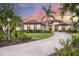 Lovely home featuring an immaculate lawn, paved driveway, and well-maintained landscaping at 3519 Founders Club Dr, Sarasota, FL 34240