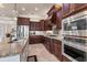 Gourmet kitchen features granite countertops, stainless appliances, and dark wood cabinets at 3519 Founders Club Dr, Sarasota, FL 34240