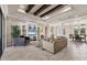 Open-concept living room with built-ins, coffered ceiling, tile floors, and access to dining room at 3519 Founders Club Dr, Sarasota, FL 34240