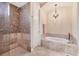 This main bathroom offers a tiled shower, soaking tub and a chandelier at 3519 Founders Club Dr, Sarasota, FL 34240