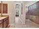This main bathroom offers a walk-in shower, granite countertops and access to the main bedroom at 3519 Founders Club Dr, Sarasota, FL 34240