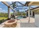 The refreshing screened-in pool features lounge chairs and a fire pit, perfect for entertaining at 3519 Founders Club Dr, Sarasota, FL 34240