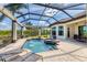 The sparkling pool and spa area features a screened-in enclosure and manicured landscaping at 3519 Founders Club Dr, Sarasota, FL 34240