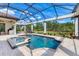 Enjoy the outdoors in this pool with a spa, patio area, and screened-in enclosure at 3519 Founders Club Dr, Sarasota, FL 34240
