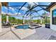 A tranquil screened-in pool area with a spa and lush landscaping at 3519 Founders Club Dr, Sarasota, FL 34240