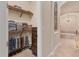 This walk-in closet features organized shelving, built-in drawers, and convenient access to the main bathroom at 3519 Founders Club Dr, Sarasota, FL 34240