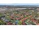 Scenic aerial view of a community near the water featuring lush landscaping and a tennis court at 3740 Pinecone Ct # 163, Sarasota, FL 34238
