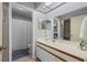 Neutral bathroom with a vanity, mirror, and a shower/tub combination behind a white shower curtain at 3740 Pinecone Ct # 163, Sarasota, FL 34238