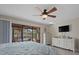Comfortable bedroom with a ceiling fan, sliding glass doors, and dressers at 3740 Pinecone Ct # 163, Sarasota, FL 34238
