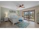 Cozy bedroom featuring a ceiling fan, sliding glass doors and nice decor at 3740 Pinecone Ct # 163, Sarasota, FL 34238
