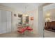 Dining area with a glass table, red chairs, pendant lighting, and a view to the outside at 3740 Pinecone Ct # 163, Sarasota, FL 34238