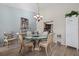 Charming dining area with a glass table, light fixture, and plant at 3740 Pinecone Ct # 163, Sarasota, FL 34238