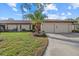 Lovely home exterior with an attached two car garage and palm tree at 3740 Pinecone Ct # 163, Sarasota, FL 34238
