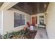 Charming front porch with a red door, lush landscaping, and a welcoming ambiance at 3740 Pinecone Ct # 163, Sarasota, FL 34238