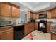 Well-maintained kitchen with dark appliances, granite countertops, and warm wood cabinetry at 3740 Pinecone Ct # 163, Sarasota, FL 34238