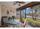 Relaxing screened-in lanai featuring a ceiling fan and comfortable seating area with a glass table at 3740 Pinecone Ct # 163, Sarasota, FL 34238