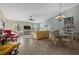 Spacious living area with vaulted ceiling, wood floors, ceiling fan and dining area adjacent at 3740 Pinecone Ct # 163, Sarasota, FL 34238
