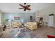 Bright living room featuring cozy yellow sofas and a unique ceiling fan at 3740 Pinecone Ct # 163, Sarasota, FL 34238