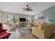 Bright and airy living room featuring comfortable seating, a ceiling fan, and ample natural light at 3740 Pinecone Ct # 163, Sarasota, FL 34238
