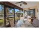 Covered patio with outdoor seating, a glass table, and views of the landscaped yard at 3740 Pinecone Ct # 163, Sarasota, FL 34238