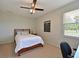 Bedroom with a queen size bed, ceiling fan and lots of natural light at 4412 Wolf Ridge Xing, Parrish, FL 34219