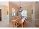 Charming dining room featuring a wooden table set, elegant chandelier, and serene window view at 4412 Wolf Ridge Xing, Parrish, FL 34219
