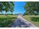 Charming single-story home with a spacious three car garage and paver driveway surrounded by lush green lawn and mature trees at 4412 Wolf Ridge Xing, Parrish, FL 34219