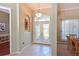 Elegant foyer with decorative tile flooring, a chandelier, and a view into the dining area at 4412 Wolf Ridge Xing, Parrish, FL 34219