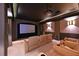 Home theater with tiered seating, ambient lighting, and a large projection screen at 4412 Wolf Ridge Xing, Parrish, FL 34219