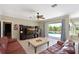 Comfortable living room with entertainment center and sliding glass doors to the outdoor pool area at 4412 Wolf Ridge Xing, Parrish, FL 34219