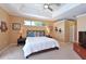 Inviting bedroom with tray ceiling and ample natural light at 4412 Wolf Ridge Xing, Parrish, FL 34219