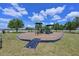 Community playground with modern play equipment, picnic pavilion, and lush landscaping at 4412 Wolf Ridge Xing, Parrish, FL 34219