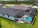 An aerial view of the backyard pool with a screened enclosure and well maintained lawn at 4509 95Th E Ter, Parrish, FL 34219