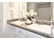 Bathroom boasts dual sinks with granite counters and white cabinets at 4509 95Th E Ter, Parrish, FL 34219