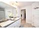 Bathroom with double vanity, granite countertop, and white cabinets and trim at 4509 95Th E Ter, Parrish, FL 34219