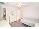 Bedroom featuring a window, dresser, neutral carpet, and bright white walls at 4509 95Th E Ter, Parrish, FL 34219