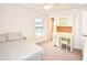 Bedroom featuring a ceiling fan, neutral carpet, a desk, and a window at 4509 95Th E Ter, Parrish, FL 34219