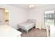 This bedroom has a ceiling fan, a bed, a window, and carpeted floors at 4509 95Th E Ter, Parrish, FL 34219