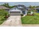 Charming single-Gathering home with a gray two-car garage, well manicured lawn and tasteful landscaping at 4509 95Th E Ter, Parrish, FL 34219