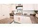 Well-lit kitchen with granite countertops, stainless steel appliances, and ample counter space at 4509 95Th E Ter, Parrish, FL 34219