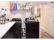 Functional laundry room features black washer/dryer, wire shelving, and storage for cleaning supplies at 4509 95Th E Ter, Parrish, FL 34219